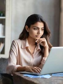 Woman contemplating looking at laptop