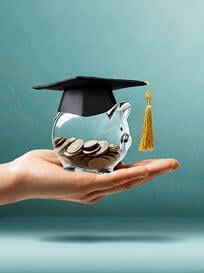 A glass piggy bank with a graduation hat.