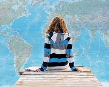 Girl looking at world map