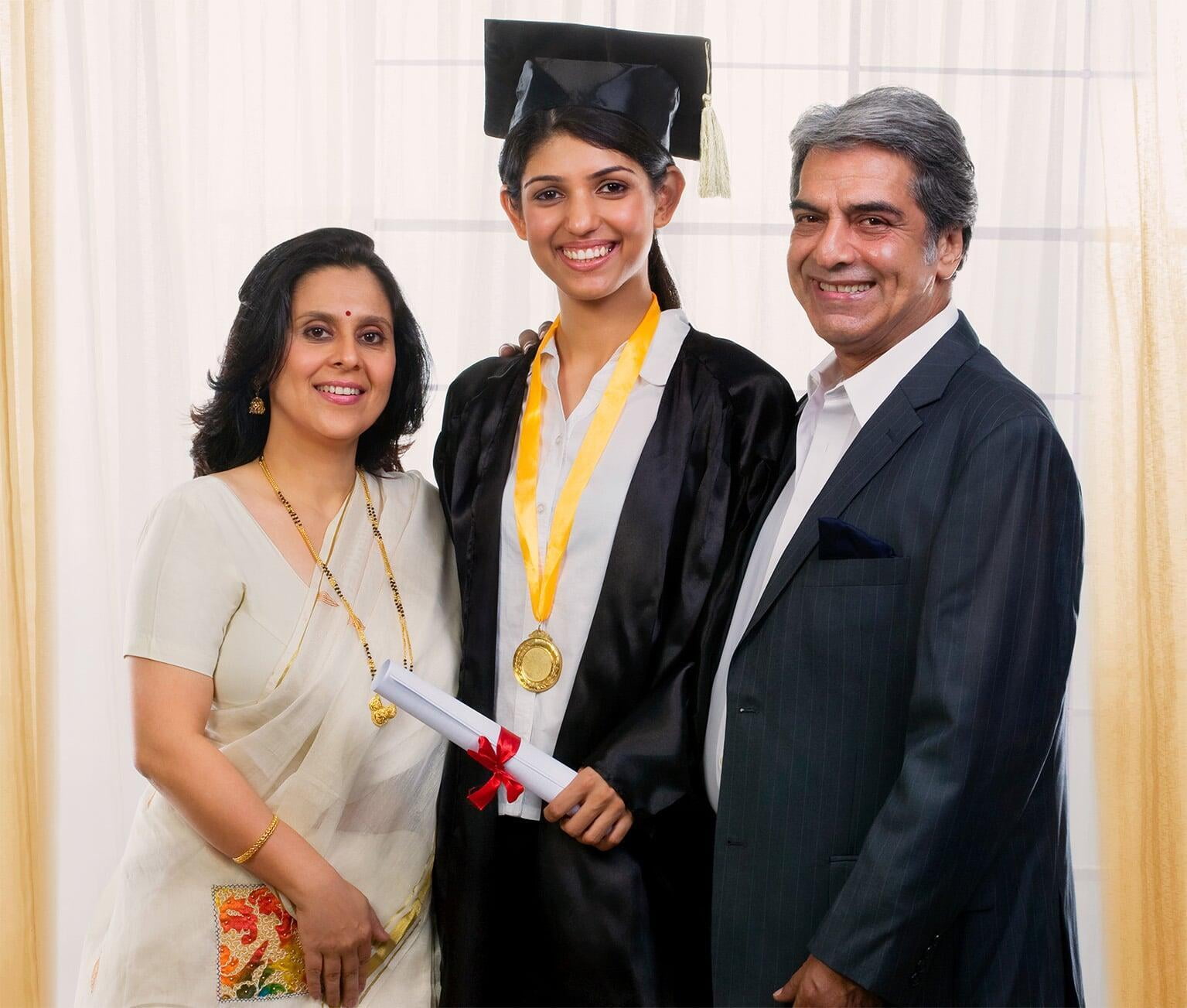 Graduate girl posing with her parents