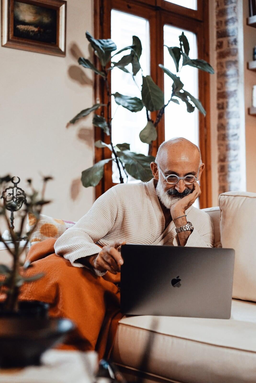 Happy and satisfied parent reading on laptop